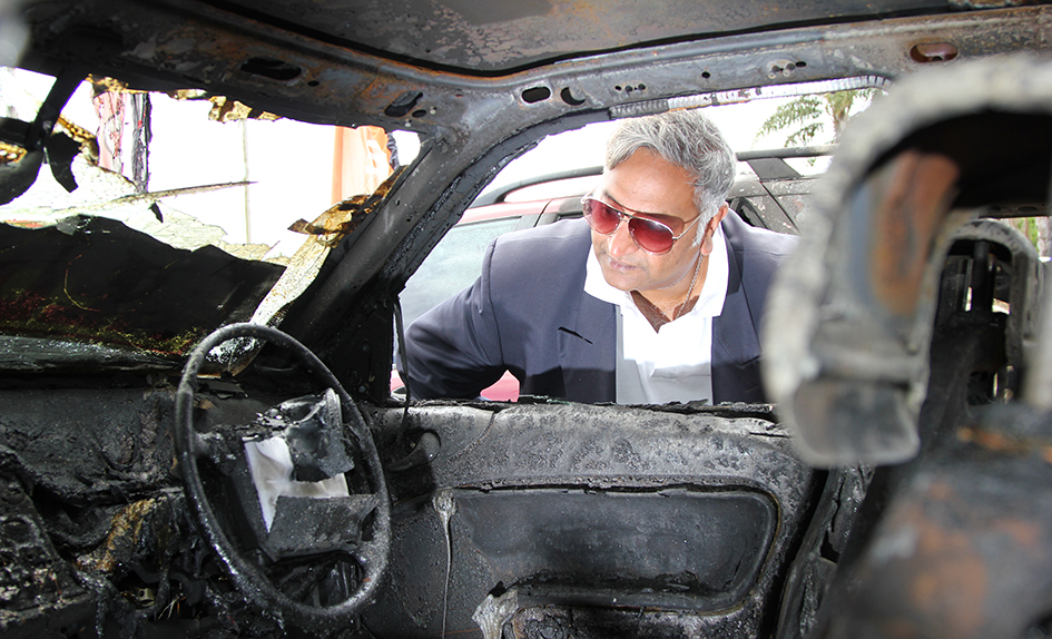 Burnt out: Longbeach Autos owner Gerry Marciny, above, inspects one of the cars  destroyed in Saturday’s blaze. Picture: Cameron McCullough