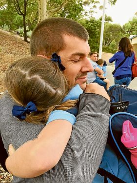 Loving father and husband: Mr Matthews hugs his daughter Annabel on her first day of school this year. 