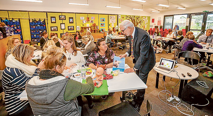 Language priority: Professor Joseph Sparling talks with parents and teachers at Seawinds Community Hub about his educational  program being adopted by Eastbourne Primary School. Picture: Yanni