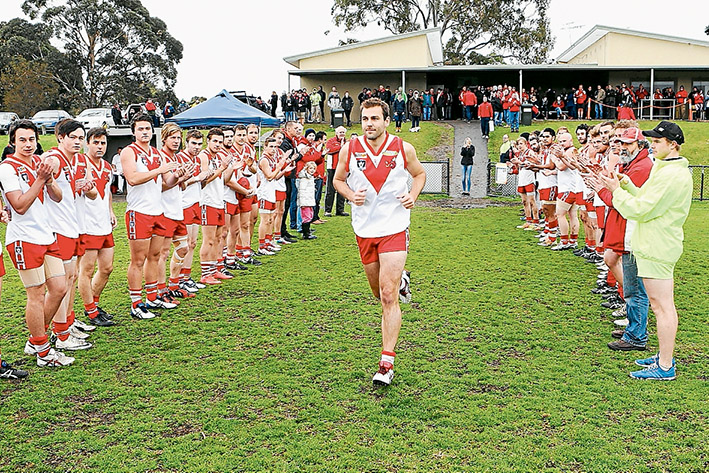 Guard of honour: Luke Van Raay runs out for his 250th game for his beloved Karingal Football Club. Picture: Andrew Hurst