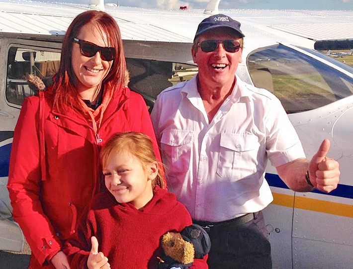 Flying high: Peter Moran and passengers Kyla, 8, and mum Tamara, at Bankstown after their Angel Flight from Hillston, NSW.