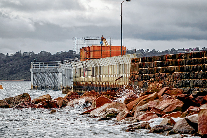 Three-parter: The three stages of the pier can be seen from the seaward side – the section built last century of bluestone, the middle section built in 2010-11 and the outer section started last year. The two new parts have 15-tonne concrete wave screens to protect the harbour. Picture: Yanni