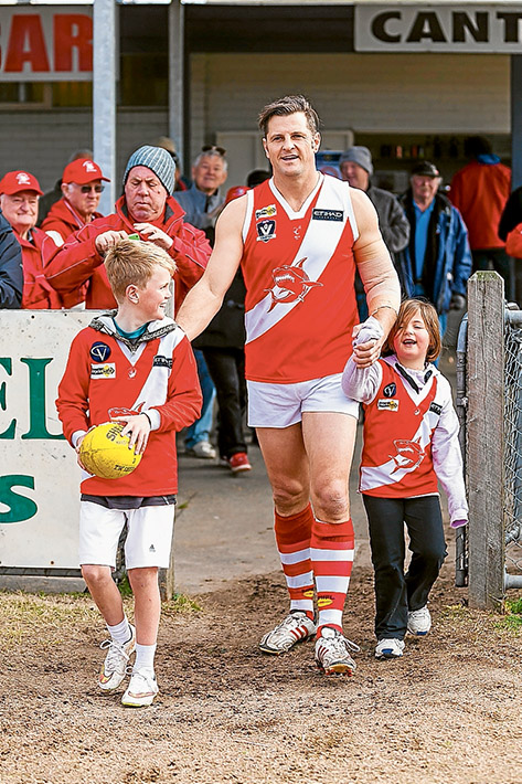 Family man: Guy Stringer comes onto the ground for his 400th game with son Archie and daughter Olivia by his side. Picture: Andrew Hurst