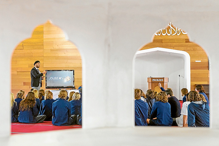 Faith talks: Padua College students James Beard and Saskia Kalkbrenner with Iman Syed Wadood Janud at the Bait-ul-Salam Mosque, Langwarrin.                    Picture: Gary Sissons  