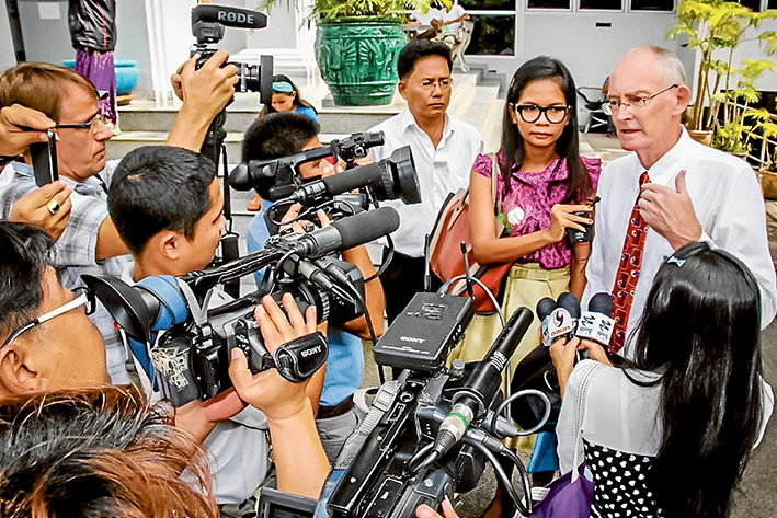 Making news: Alan Morison, right, and Chutima Sidasathian, centre, face the media during their trial in Thailand. They were cleared of criminal defamation charges last week. Picture supplied