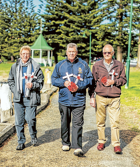 Lest we forget: John Phillingham, left, Michael Jeffreson and Peter Munro pay their respects to the war dead of Sorrento. Picture: Yanni