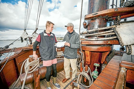 Sailing mates: Enterprize captain Kevin Martin presents Nathaniel Grieef-Dickerson, of Mt Eliza, a year 10 student at Peninsula School, with a certificate of achievement.