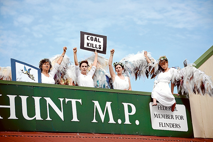 Angels on high: Climate Guardians clambered to the roof over MP Greg Hunt’s Hastings office on Friday afternoon as part of the ongoing activism against the federal government’s positive policies towards coal mining. Picture: Jarryd Bravo