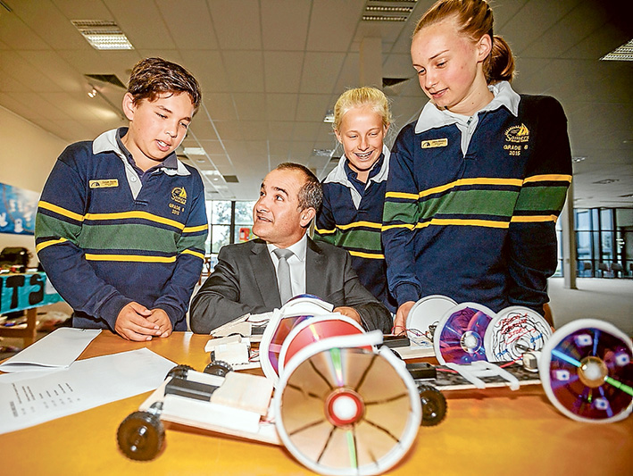 All the fun of the fair: left, Education Minister James Merlino with Somers Primary School pupils Cooper Squire, Zara Belle and  Joanna Mikkelson. Right, Brendon, Aaron and Jake from Tyabb Railway Primary School demonstrate their coloured  water droplet experiment. Below, Luke, Tara, Pia, Luke and Henry from Balnarring Primary School use entertainment to showcase science. Pictures: Yanni