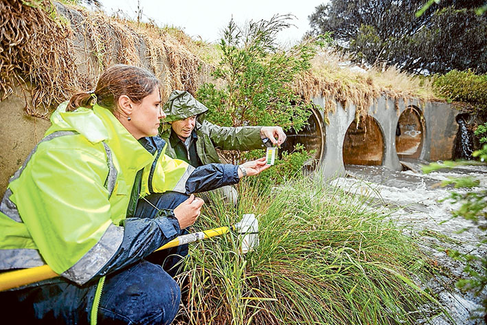Water quality: EPA project officer Melissa Burrage and the shire’s senior environmental health officer Peter O’Brien test the raging waters of Tanti Creek Mornington. Picture: Yanni