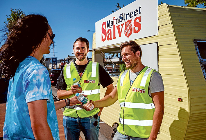 Ready to serve: Mornington Salvation Army officer Sean Mapleback along with volunteers like Sam Hearne will hand out water and snacks to late night revellers like Te Tai Atkins as they leave the pubs and clubs. Picture: Yanni