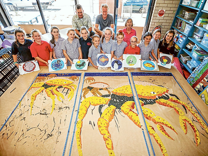 Colourful creation: Artist Simon Normand, action group president Michael Wittingslow and teacher Mechelle Cheers with the grade 5 mosaic makers. They are Tiah, Skye, Casey, Keely, Greta, Jemma, Ashley, Imogen, Caitlyn, Faizah, Ocearna and Billie. Picture: Yanni