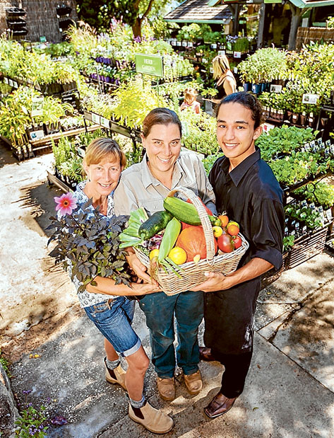 Prized produce: Robyn Schuurman, Robyn Fox and Brayden Logan – Gusti with a basketful of some of Heronswood’s current crop. Picture: Yanni