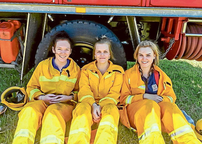 Break time: CFA firefighters Ally Smith (Bittern) Alicia Jackson (Crib Point) and Bree Carrigg (Somerville) take a break from firefighting duties. Picture: Adam Carrigg