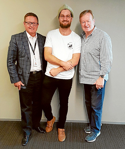 Here’s to you: Sam Keck, centre, with Momentum Energy’s Paul Geason, left, and 3AW’s Denis Walter.