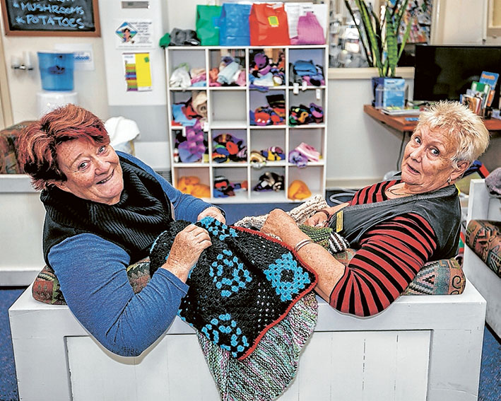 Stitch in time: Volunteers Bev Storey and Cynthia Emery with knits for those in need at Southern Peninsula Community Support and Information Centre. Picture: Yanni
