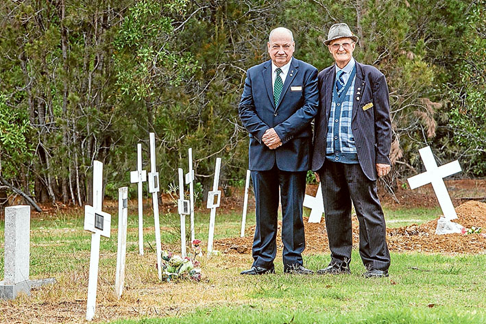 Fitting send-off: Funeral director Brian McMannis and Crib Point Cemetery treasurer Clem Kleinig beside crosses marking the “paupers” graves. Picture: Gary Sissons