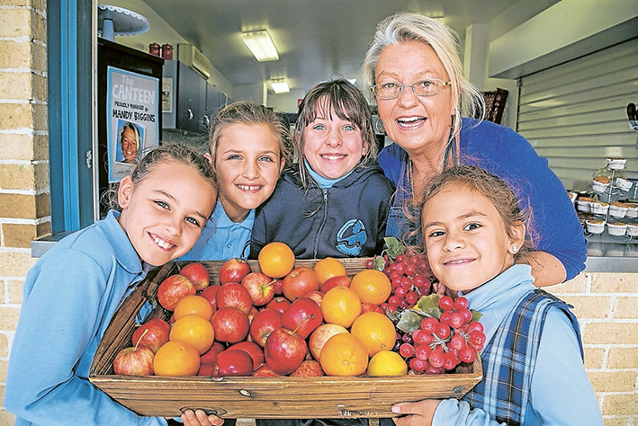Yum yum: Canteen manager Mandy Biggins, herewith Francesca, Lilka, Brigitte and Saskia, says Kunyung pupils look forward to meal times now.                Picture: Gary Sissons