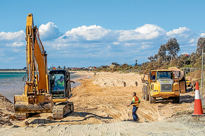 Watery world: The state government’s environment department spread 15,000 cubic metres of sand on Frankston beach in November 2013 after it had been removed by storms. By early January 2014 the sea had taken almost half. Picture: Gary Sissons