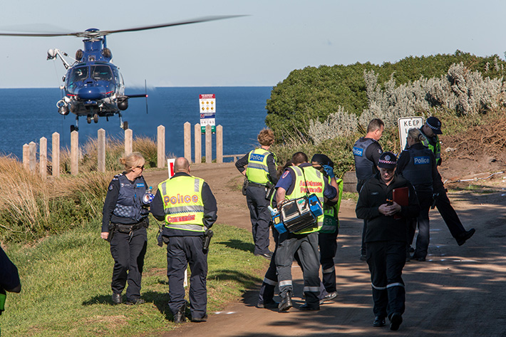 Fatal Crash Blowhole Flinders. I have been told it was a suicide but this was unconfirmed. The car looks like it hit the traffic island on blowhole track at speed, It became airborne and went over the cliff landing on the rocks below. Photo: Emergency services and the Police Air Wing survey the scene.