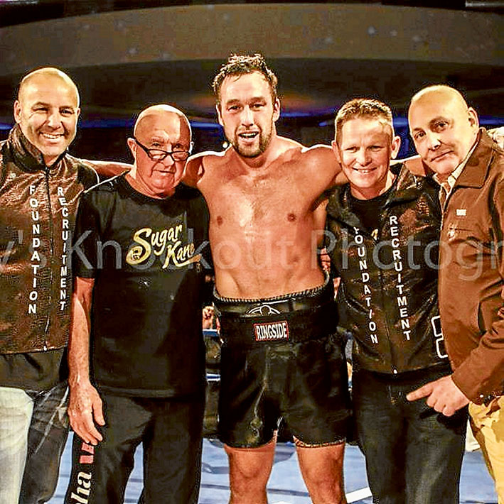 Title win: Bittern boxer Kane Watts in the ring after Friday night’s win with Paul Gay, Ray Giles, Julian Holland and Brian Amatruda.