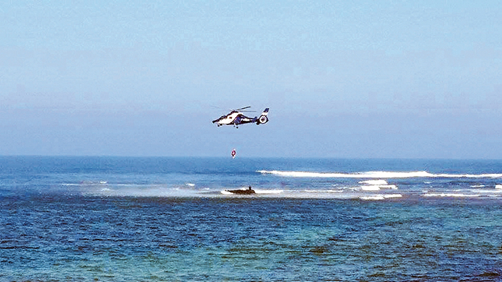 Timely pick up: Two teenagers are plucked to safety by the police Air Wing Sunday afternoon from Mushroom Reef, Flinders. Picture: Matt Drysdale 