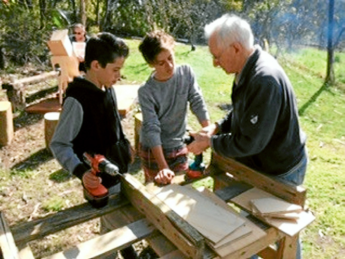 Boxing lesson: Richard from Mornington Men’s shed helping Flynn and Trinity build a nesting box.