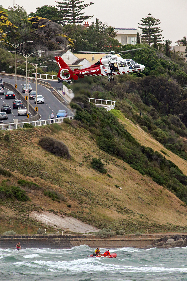 Drowning Frankston Beach. Contact Peter Edwards 0409 865 903 Peter and his 17yo son pulled 4 people from the rough seas. Although a 5th person drowned. Photo: Air Ambulance and a Zodiac search the water off Oliver's hill.