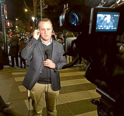 Paris calling: Human Rights Commissioner Tim Wilson, above, prepares to broadcast live from Paris. Lauren De Rycke, below, was safely in a hotel room when the terrorists attacked.