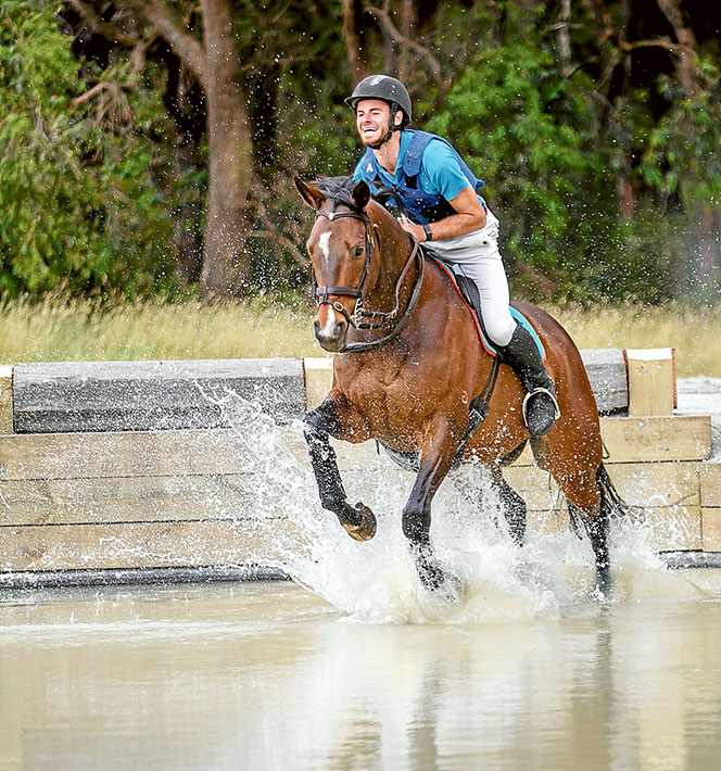 Splish, splash: Charlie King puts Jag through his paces at the new water jump complex at Main Ridge. Picture: Yanni