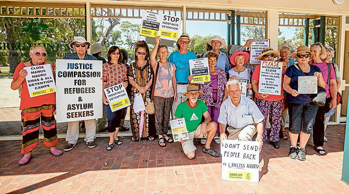 Signs of protest: Members of Amnesty International’s Mornington Peninsula branch outside Flinders MP Greg Hunt’s office show what they think about the government’s asylum seeker policies. Picture: Yanni