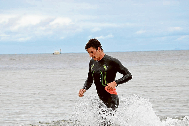 Home first: Jackson Coote, above, was the fastest individual swimmer home in the Bloody Big Swim, in 2.50.49, followed by David Fraser, 2.56.11. The first individual female across the line was Lisandra De Carvalho, below, in 3.03.49.