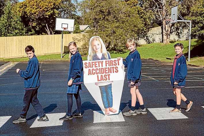 Read all about it: St Thomas More Primary pupils show off their winning signs in Canadian Bay Rd, Mt Eliza. Picture: Gary Sissons