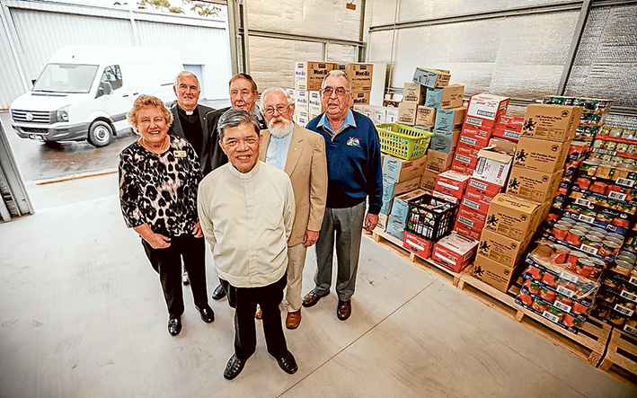 Helping hand: Diane Falconer, Fr Kevin Davine, Ken Northwood, Reverend Murray Morton, Cyril Mahon and Fr Bart Huynh San in front. Picture: Yanni