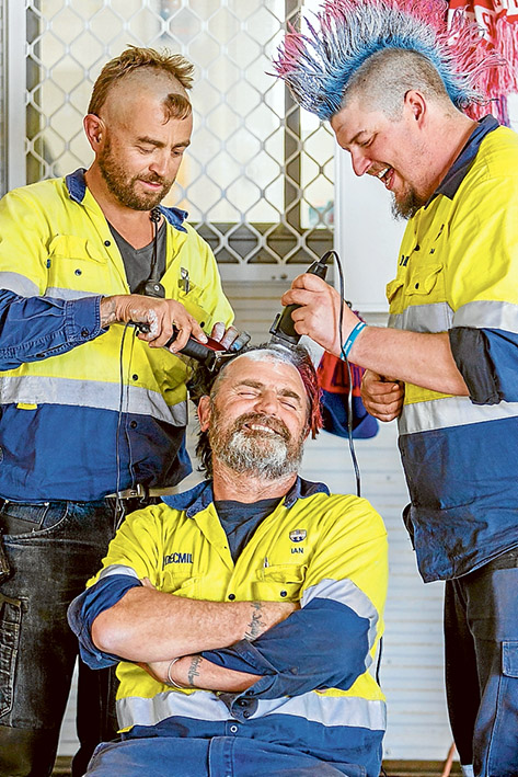 Shane Bisby and Ryan Jackson work on the rest of Ian Stead's head.