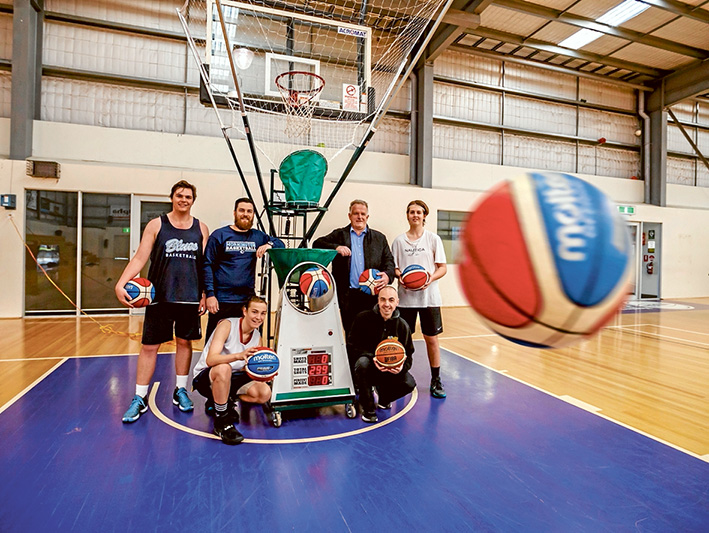 Ring it: Mornington students Marley Thompson, Jakob Gorman and Brodie Eaton test out the basketball machine with Year 8 teacher and coach Jason Darlington, MDBA coaching director Chris Jannese and donor Martin Scanlon. Picture: Yanni