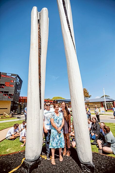 Garden feature: Michael Mann’s children, Josh, Sam, Sarah with their mother Jenny, stand with The Guardians, the carved centrepiece of the garden created in memory of their father and husband, Michael Mann. Picture: Yanni