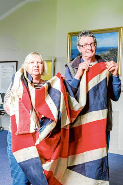 Flag bearers: Dromana and District Historical Society president Jean Rotherham and historian Fred Wild with the Union Jack that renowned artist Ewart Melbourne Brindle took to the United States in 1918, above, and drawing books from his days at Dromana State School. Pictures: Keith Platt