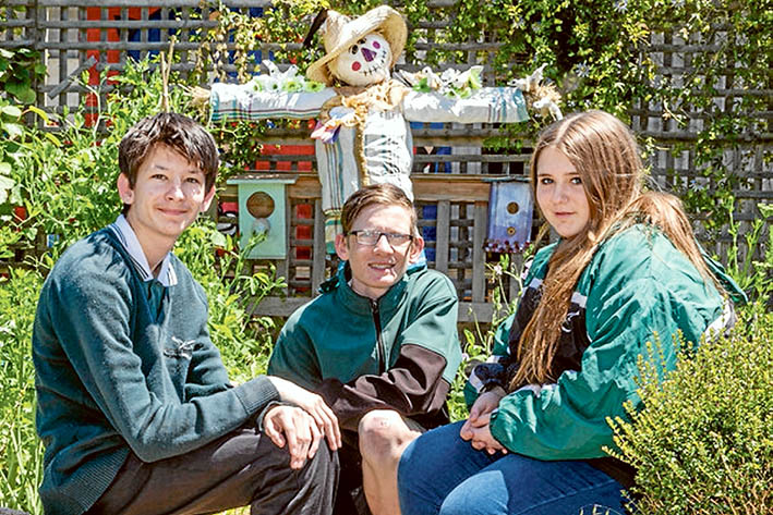 Flinders the Scarecrow shows that gardens provide food, shelter and beauty. Time spent in the garden is never time wasted, according to Jackson, Matt and Simone. Pictures: Gary Sissons